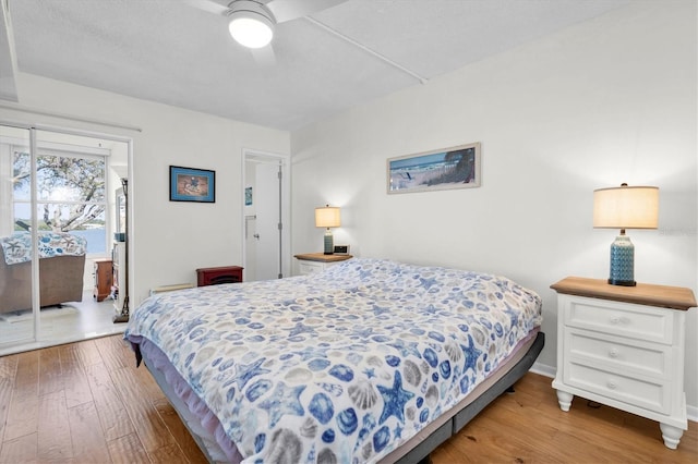 bedroom featuring access to exterior, baseboards, ceiling fan, and hardwood / wood-style floors