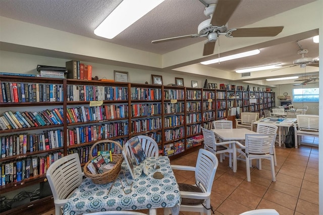 tiled dining area featuring visible vents, ceiling fan, and a textured ceiling