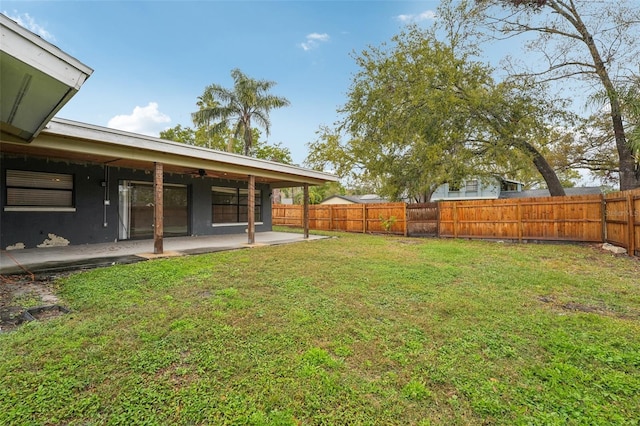 view of yard with a fenced backyard, ceiling fan, and a patio