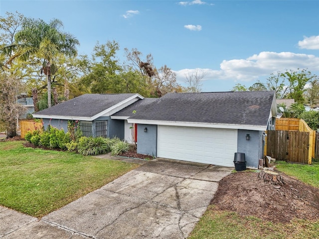 ranch-style home featuring stucco siding, concrete driveway, a front lawn, and fence