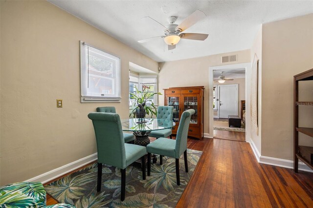 dining space featuring a ceiling fan, wood-type flooring, visible vents, and baseboards