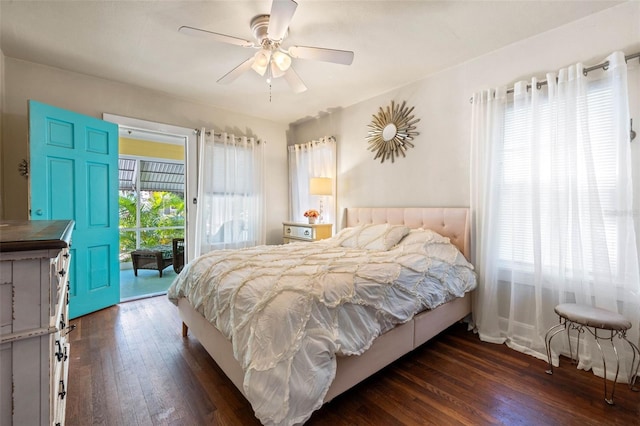 bedroom with access to outside, multiple windows, dark wood finished floors, and a ceiling fan