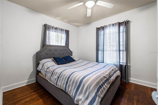 bedroom featuring ceiling fan, baseboards, and wood finished floors