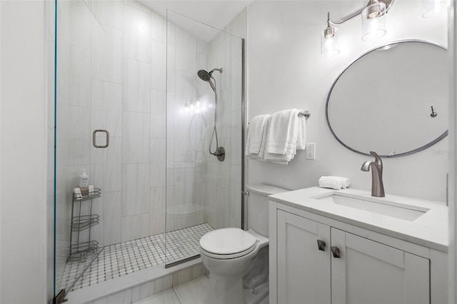 full bathroom featuring a shower stall, toilet, and vanity