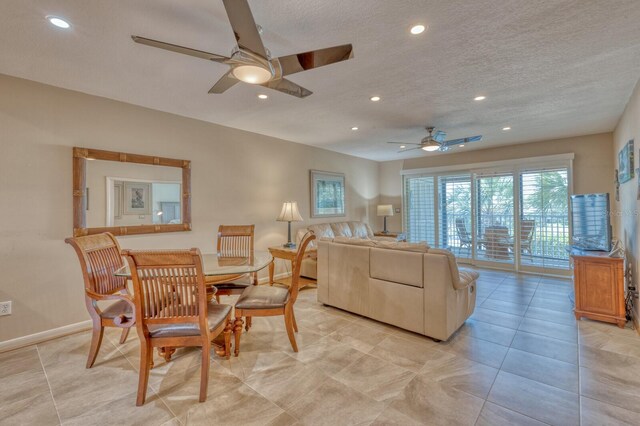 living room featuring a textured ceiling, ceiling fan, light tile patterned floors, recessed lighting, and baseboards