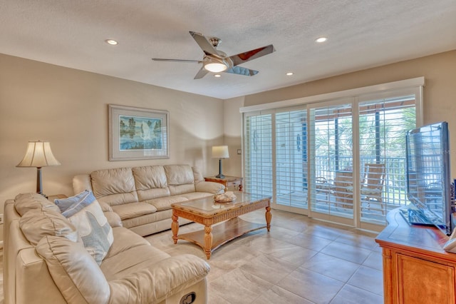 living area featuring recessed lighting, ceiling fan, and a textured ceiling