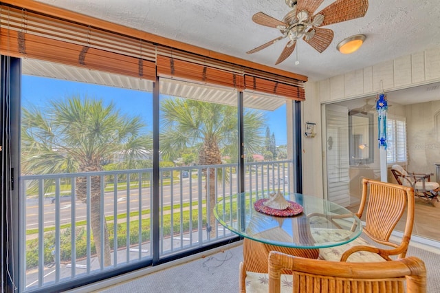 dining space featuring a ceiling fan and a textured ceiling