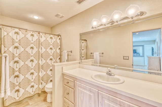 bathroom featuring visible vents, tile patterned flooring, vanity, and toilet