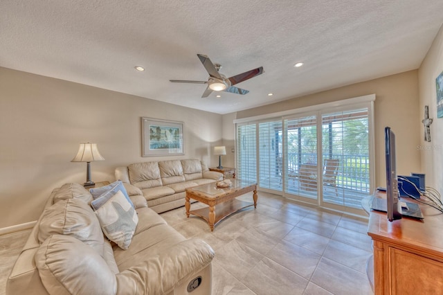 living area with a ceiling fan, recessed lighting, and a textured ceiling