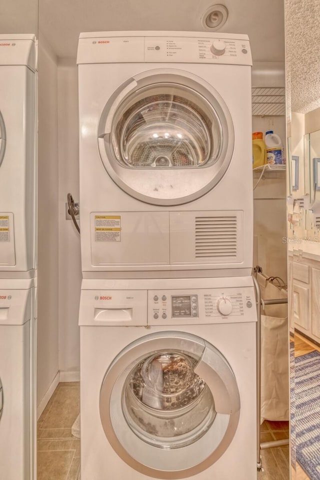 laundry area featuring laundry area and stacked washing maching and dryer