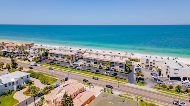 bird's eye view featuring a water view and a beach view