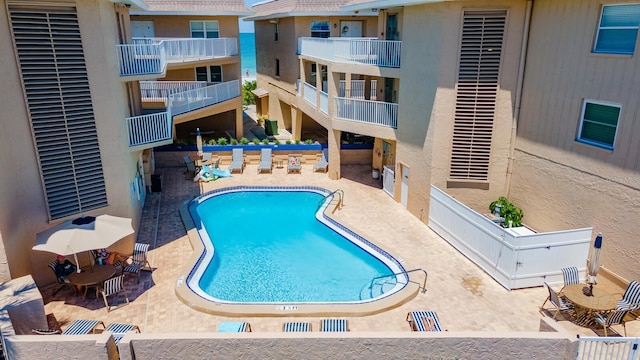 community pool with a patio area