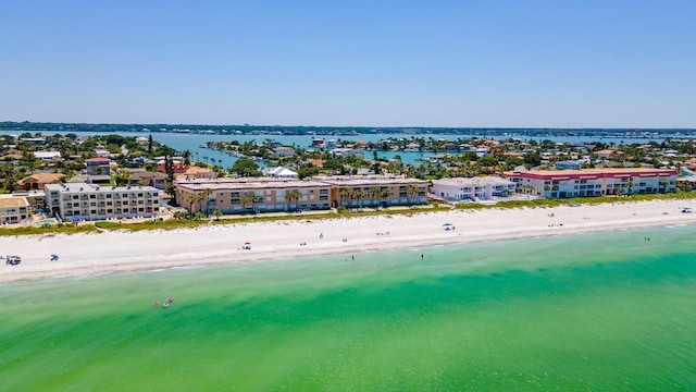 birds eye view of property with a water view and a beach view