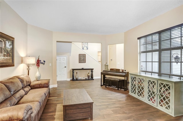 living area with baseboards and wood finished floors