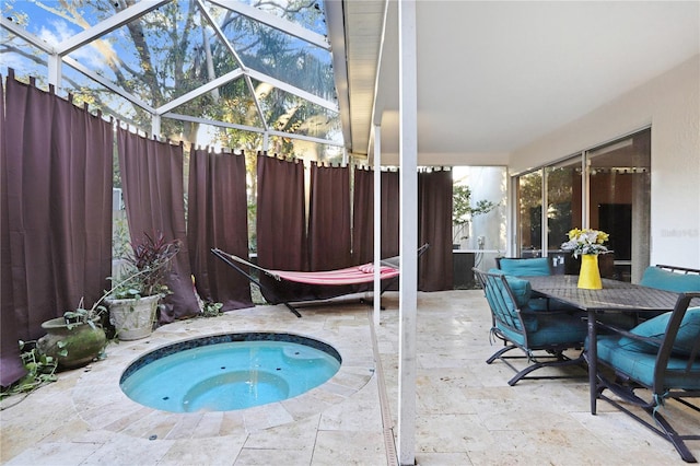 view of pool with a patio, a lanai, fence, and an in ground hot tub