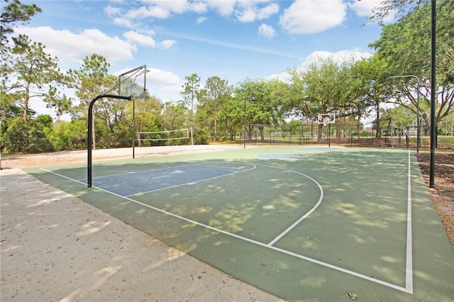 view of sport court featuring community basketball court, fence, and volleyball court