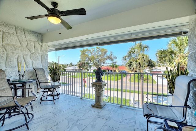 balcony with ceiling fan and a residential view