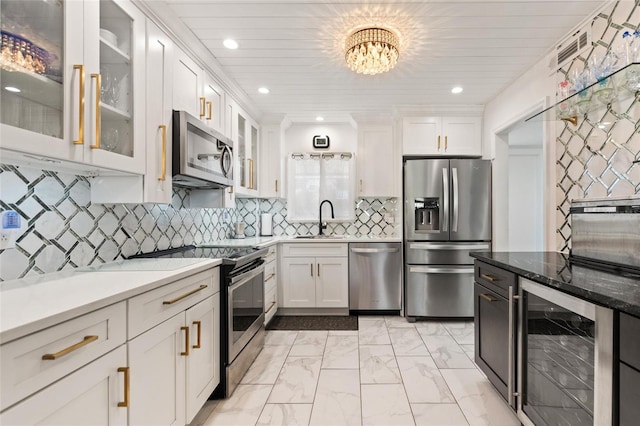 kitchen with white cabinets, marble finish floor, wine cooler, and stainless steel appliances