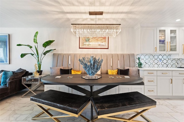 dining space featuring breakfast area and marble finish floor