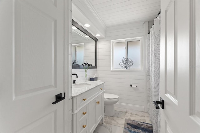 bathroom with marble finish floor, crown molding, toilet, wood walls, and vanity