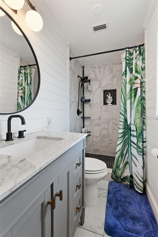 bathroom with visible vents, marble finish floor, tiled shower, and vanity