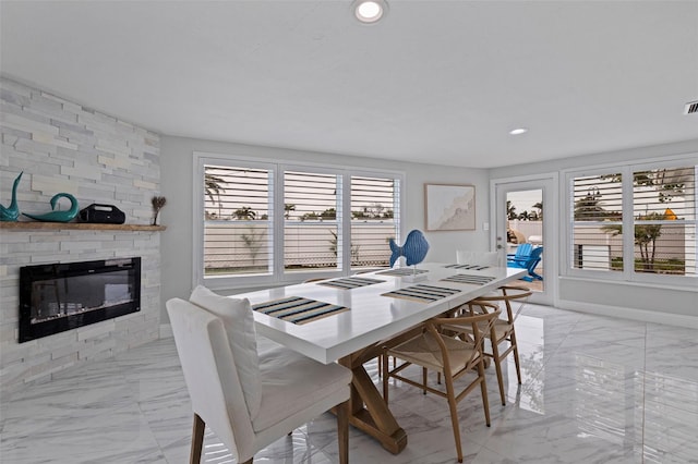 dining space with visible vents, baseboards, a fireplace, recessed lighting, and marble finish floor