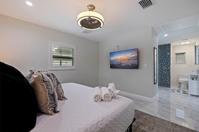 bedroom featuring visible vents, baseboards, attic access, and ensuite bath