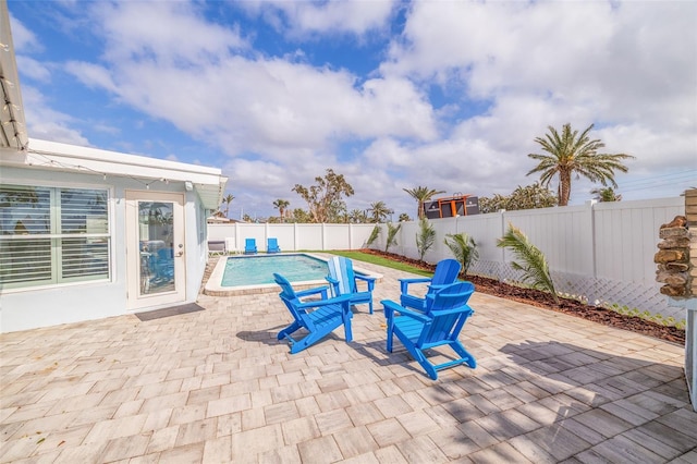 view of swimming pool with a patio area, a fenced in pool, and a fenced backyard