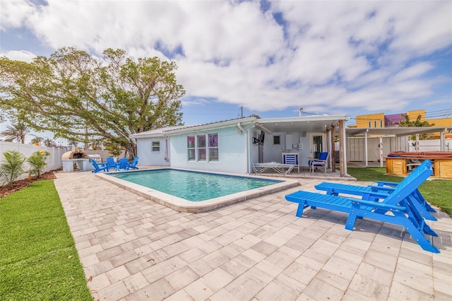 view of swimming pool with a patio, a fenced backyard, a fenced in pool, and a hot tub