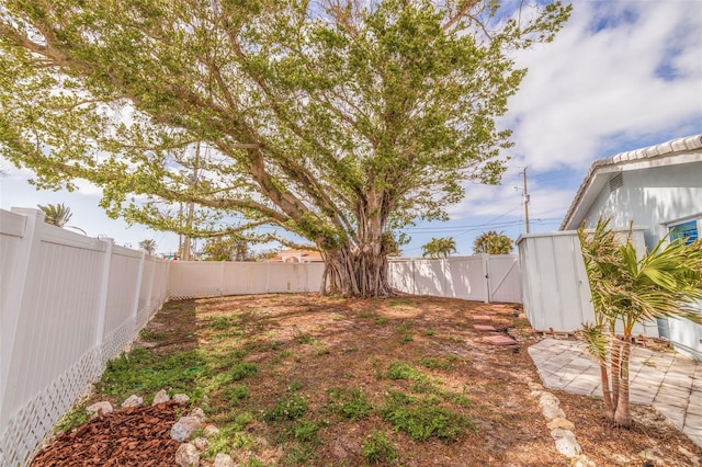 view of yard featuring a gate and a fenced backyard