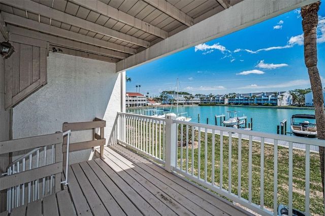 balcony featuring a boat dock and a water view