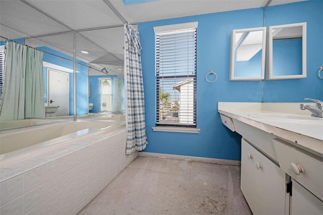 bathroom featuring tiled tub, baseboards, vanity, and a shower with shower curtain