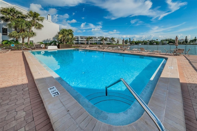 pool featuring fence and a patio