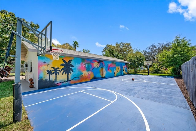 view of sport court featuring fence and basketball court