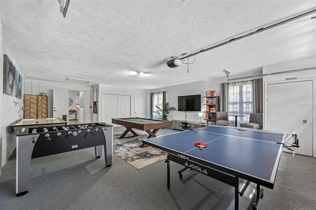 rec room with a textured ceiling, speckled floor, and billiards