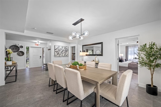 dining space with an inviting chandelier, baseboards, and visible vents