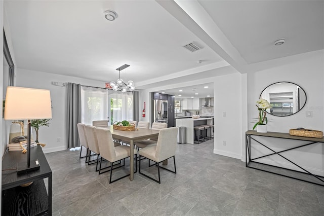 dining area with a chandelier, visible vents, and baseboards