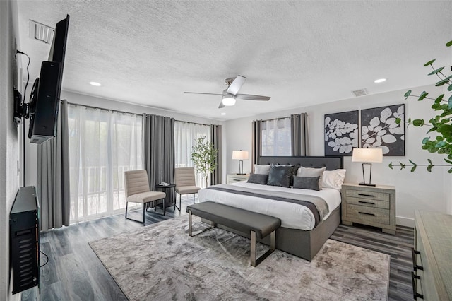 bedroom featuring a textured ceiling, wood finished floors, visible vents, a ceiling fan, and access to outside