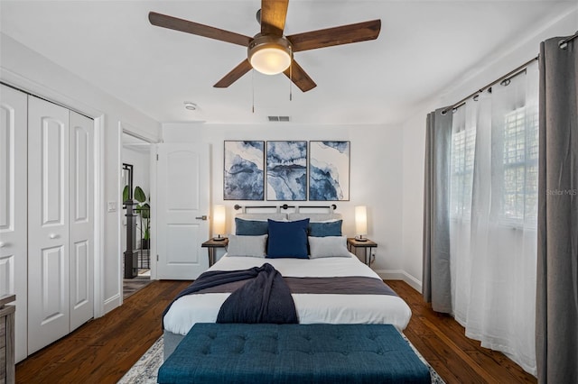 bedroom featuring a closet, visible vents, a ceiling fan, wood finished floors, and baseboards