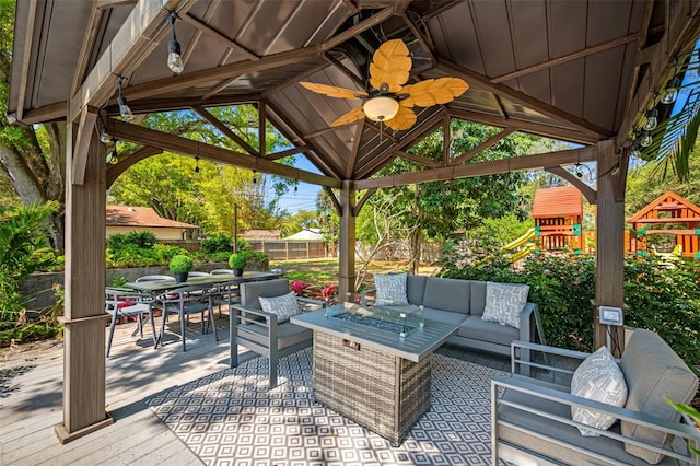 view of patio / terrace with a playground, a gazebo, an outdoor hangout area, outdoor dining space, and fence