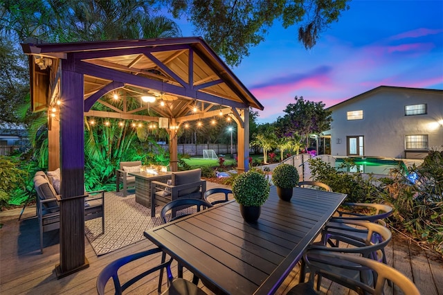 view of patio / terrace featuring an outdoor pool, fence, a gazebo, an outdoor living space, and outdoor dining space