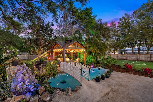 exterior space with a fenced backyard, a jacuzzi, and a patio