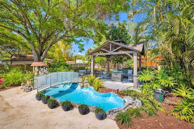 view of swimming pool featuring an outdoor hangout area, a gazebo, a patio area, and a fenced backyard