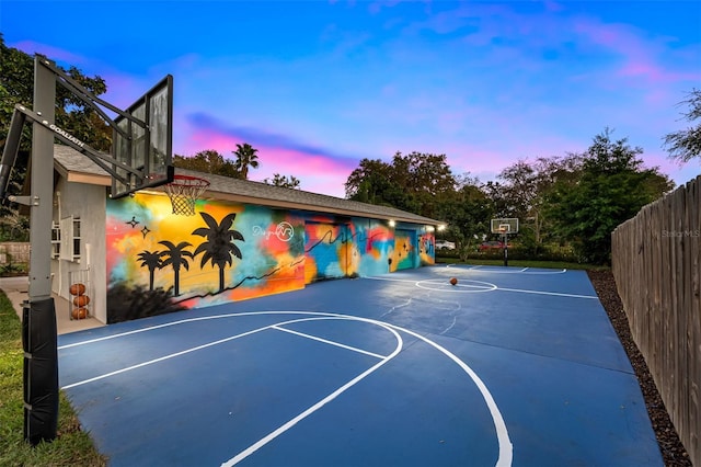 view of basketball court featuring fence and basketball court