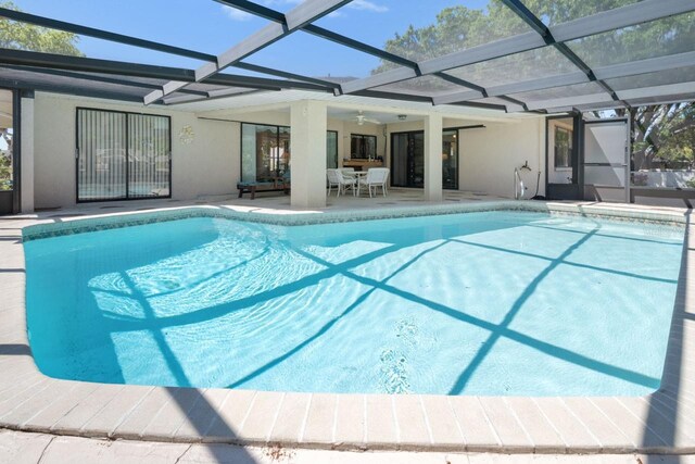 outdoor pool featuring a patio, a lanai, and a ceiling fan