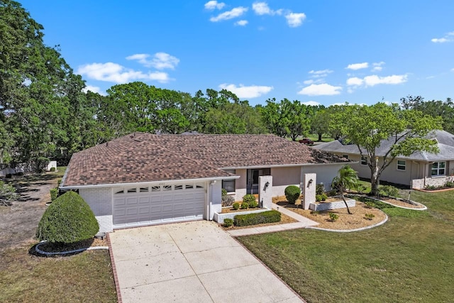 single story home featuring brick siding, an attached garage, concrete driveway, and a front yard