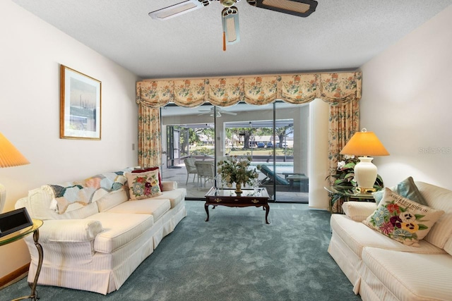 living area featuring a textured ceiling, carpet flooring, and ceiling fan