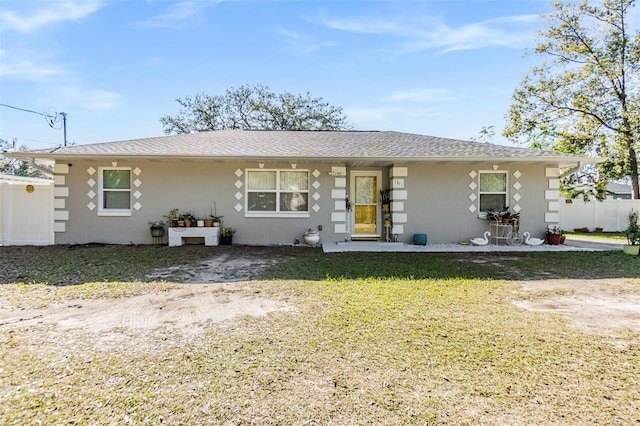 single story home with fence, a front lawn, and stucco siding