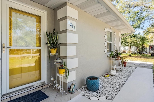 entrance to property with stucco siding