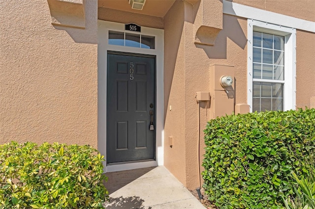 doorway to property with stucco siding